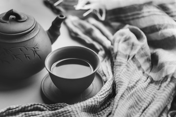 Tea ceremony: tea in a ceramic cup in monochrome; asian traditions