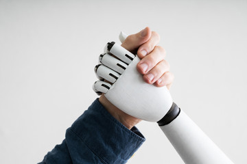 Businessperson And Robot Shaking Hands
