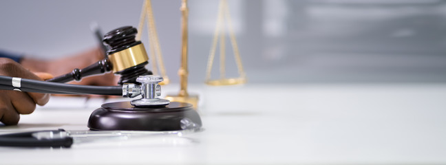 Judge Hands With Gavel And Stethoscope