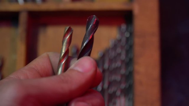 Male hand holds drills in hands