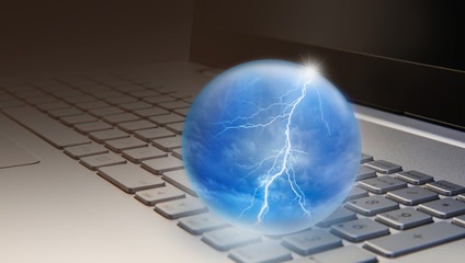 Thunder and lighning inside glass sphere on laptop keyboard "Elements of this image furnished by NASA " 