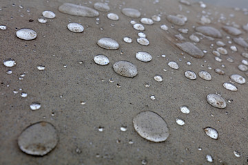 Water droplets on grey ground