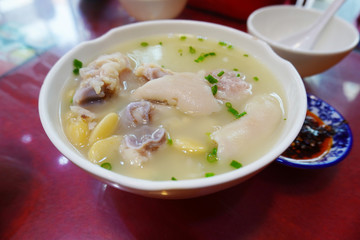 Traditional Szechuan style pork knuckles clear soup with herbs.
