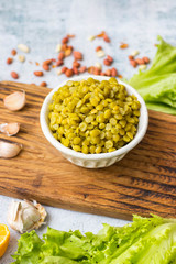 Green peas beans cooked in bowl. Table, kitchen