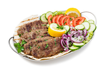 Grilled meat kebabs (cutlets) served with vegetables and tortilla, flatbread. isolated on white background