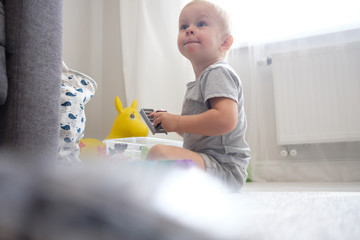 kid boy playing with toy at home or kindergarten