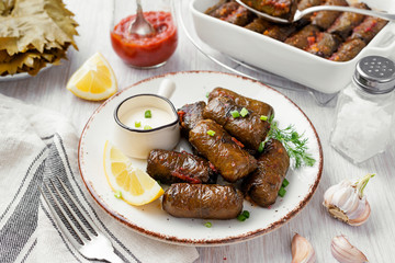 Dolma - stuffed grape leaves with rice and meat. Traditional Turkish and Greek dish