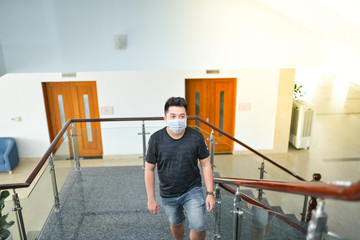 Asian man wearing medical mask at office. Wuhan China coronavirus (COVID-19) outbreak prevention. Health care and medical concept. Protection against virus, infection, exhaust.