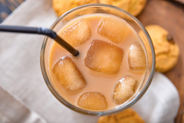 Glass of tasty iced coffee on table, closeup