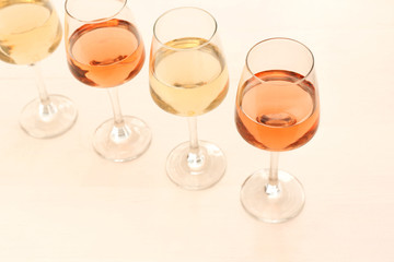 Glasses of different wine on wooden table