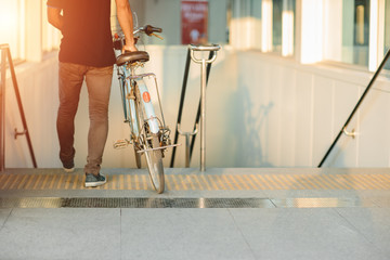 modern lifestyle of urban people using bring bicycles go with subway underground train station in...