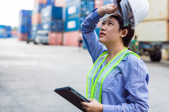 Woman Worker Tired Fatigue From Hardwork Overload And Outdoor Hot Weather Sweating In Port Cargo Shipping Industry.