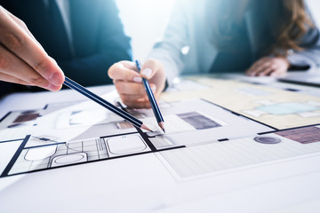 Two Architects Discussing Blueprint