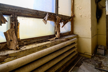 Photo of a room with the garbage of an abandoned destroyed plant. Slums, waste.