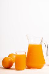glass and jar of fresh orange juice