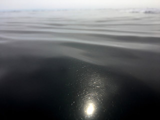 the sun's reflection on the dark ice the horizon line merges with the surface of the frozen lake