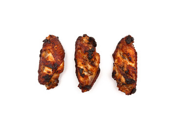 barbecue chicken wings close up on wooden tray shot with selective focus white background