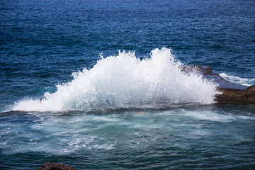 wave splashes on stones at Tenerife island, Spain, Canary islands