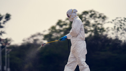 Virology scientists wear PPE kits to clean up viruses.