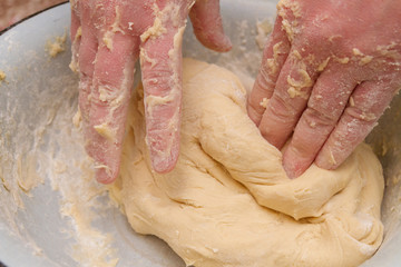 Fototapeta premium Cooking dough in a white plastic bowl at home