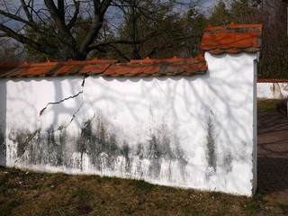 White cemetery wall with red roofing