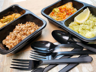 Delicious and healthy takeaway food in boxes with Cutlery.