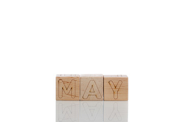 Wooden cubes with letters may on a white background