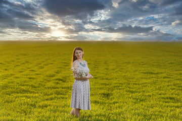 A girl walks through a grain field