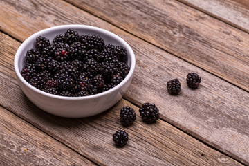 Fresh blackberries in white ceramic bowl