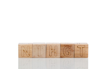 Wooden cubes with letters night on a white background