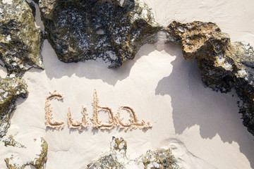 The inscription Cuba on the beach sand. Horizontal. Vertical.