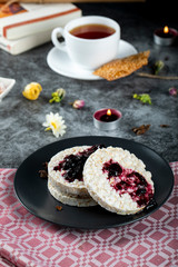 Dietary rice crackers with red berry jam and a cup of tea