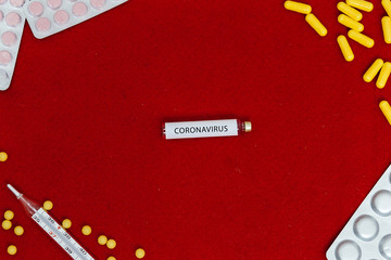 Obraz premium Abstract virus strain model of MERS-Cov or middle East respiratory syndrome coronavirus and Novel coronavirus 2019-nCoV with text on a red felt background. Flat lay.