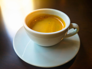 Coffee mug on wood table, cozy breakfast, vintage style , coffee shop background.