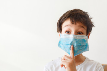 Cute little asian  boy wearing health mask, looking up, isolated over white background