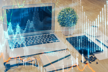 Financial market graph hologram and personal computer on background. Multi exposure. Concept of forex.