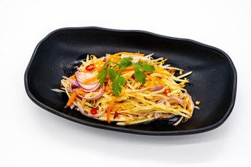 Spicy mango salad with vegetable and chili in black dish