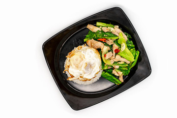 Fried Chinese Kale with chicken in black dish on white background.