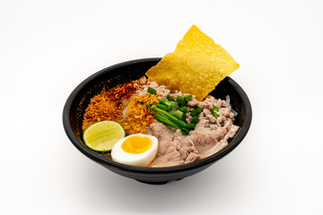 Thai Pork Noodles soup and boiled egg on white background