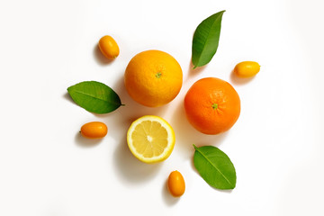 Close up image of juicy organic whole and halved oranges with green leaves & visible core texture, isolated white background, copy space. Macro shot of bright citrus fruit slices. Top view, flat lay.