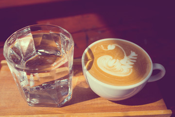 hot latte art coffee on wood table, relax time