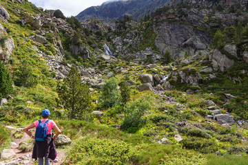 Fototapeta na wymiar View of lady hiker, going up to the lakes of Juclar. Soldeu, Andorra