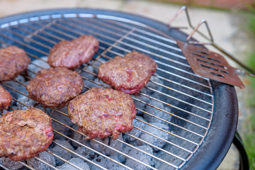 bbq grill handmade burgers cooking on hot charcoal in backyard in england uk
