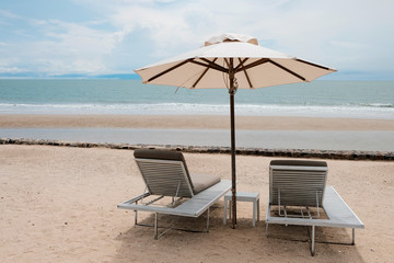 two chairs and umbrella on the beach, vacation time after covid-19