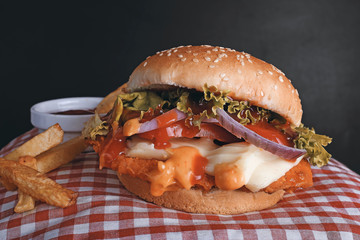 Spicy & tasty chicken burger on black background