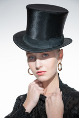 Blonde girl in retro style, top hat on her head