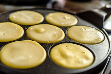 pancake frying pan with smile face pancake cooking on cooker in kitchen