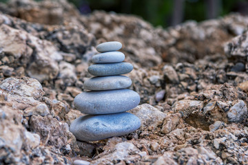 Close up stack of pebbles on the beach. View of stone tower on sea coast. 