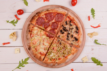 Traditional italian pizza on wooden background.Top view.