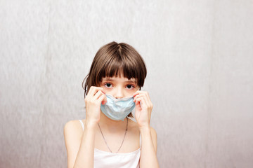 Girl with a medical mask on her face.